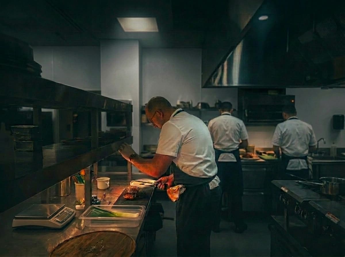 Michelin-trained ABLTY chef plating performance meals in the Washington DC commissary kitchen