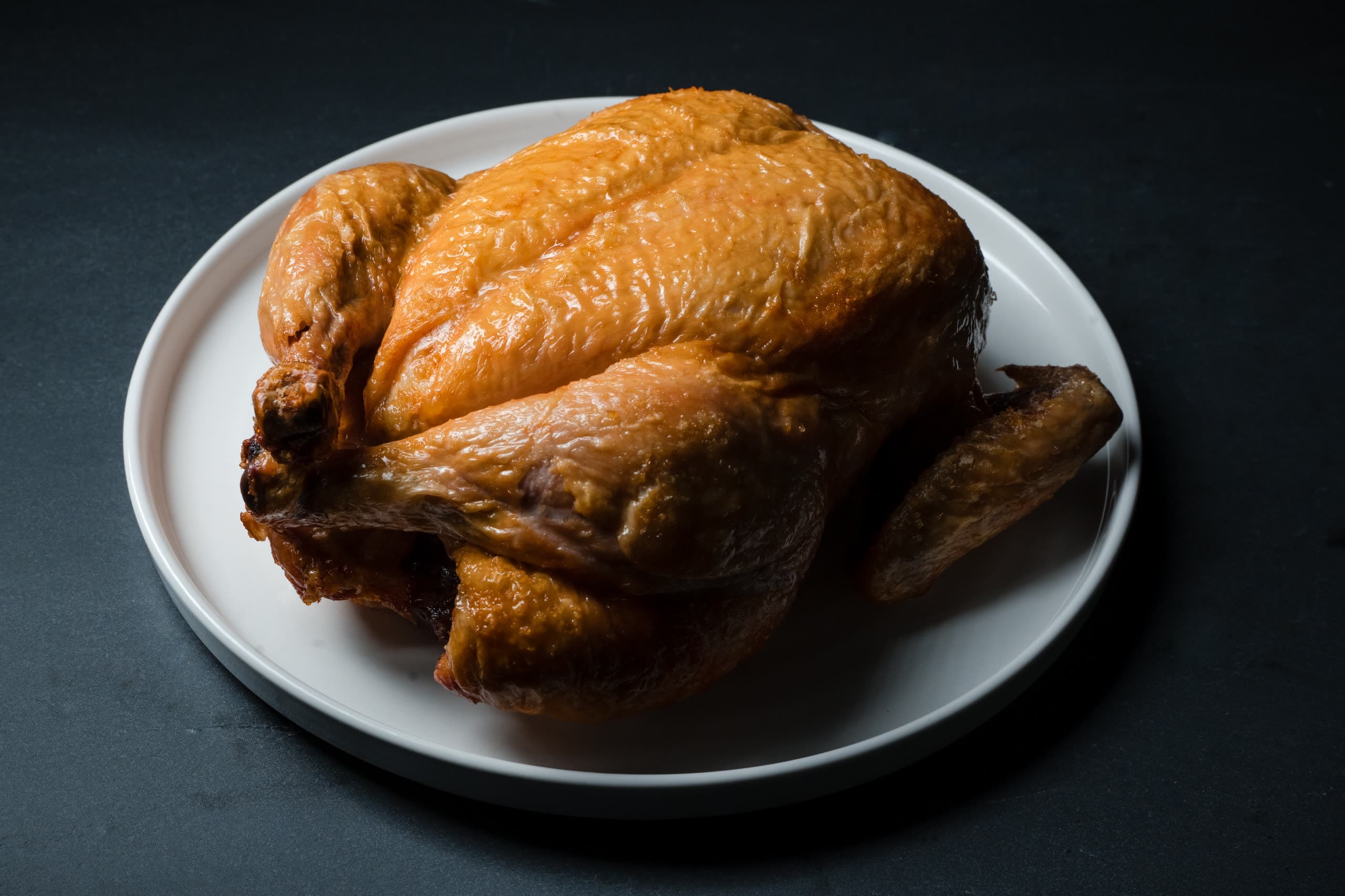 A whole roast chicken plated on the pass at ABLTY’s Dupont Circle commissary